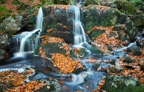 small waterfalls running over boulders in Galloway Forest Park